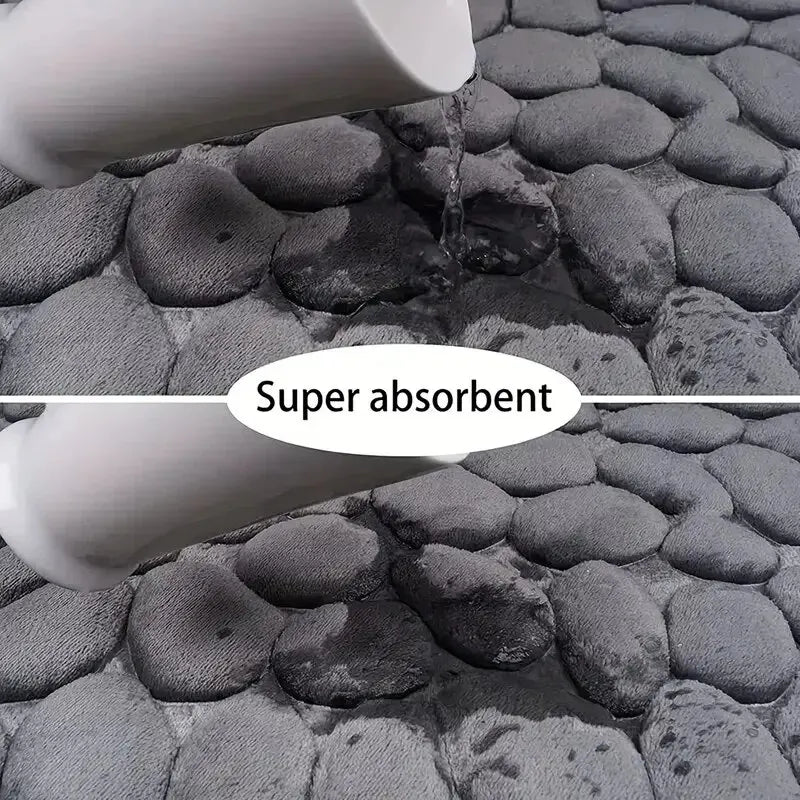 GLOBGRIP anti slip pebble floor mat showing super absorbent gray textured surface with water poured on it