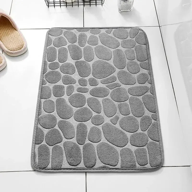 GLOBGRIP anti slip pebble floor mat in gray with textured pebble design on white tile floor