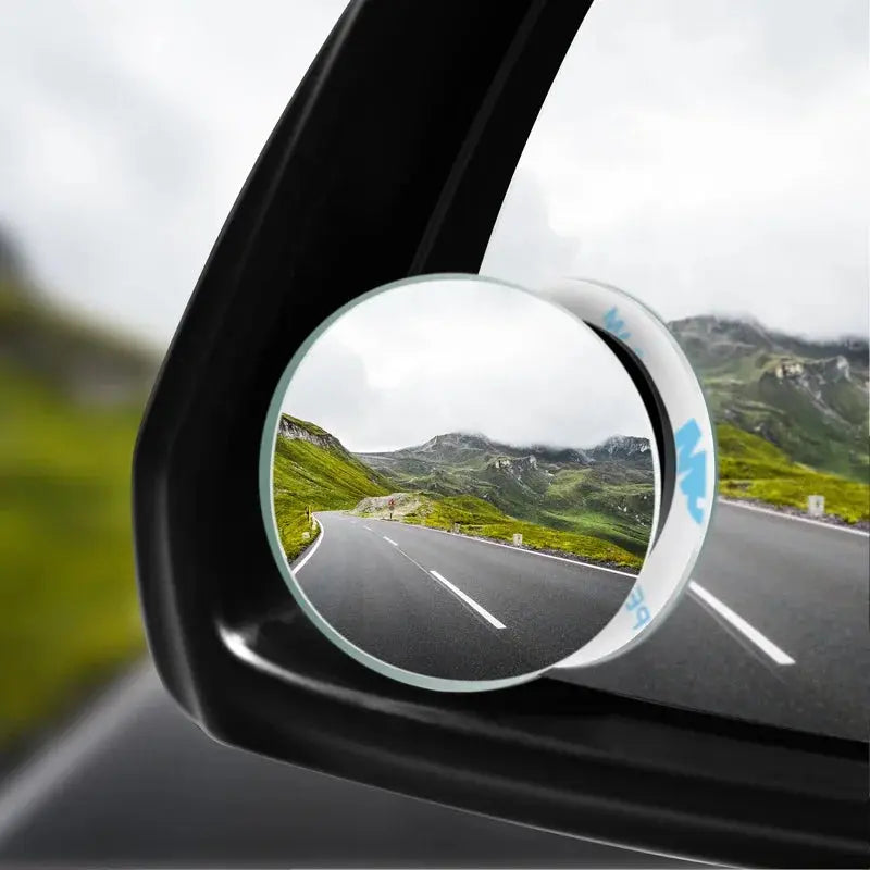 GLOBGRIP convex blind spot mirror attached to car side mirror showing clear road and mountain view